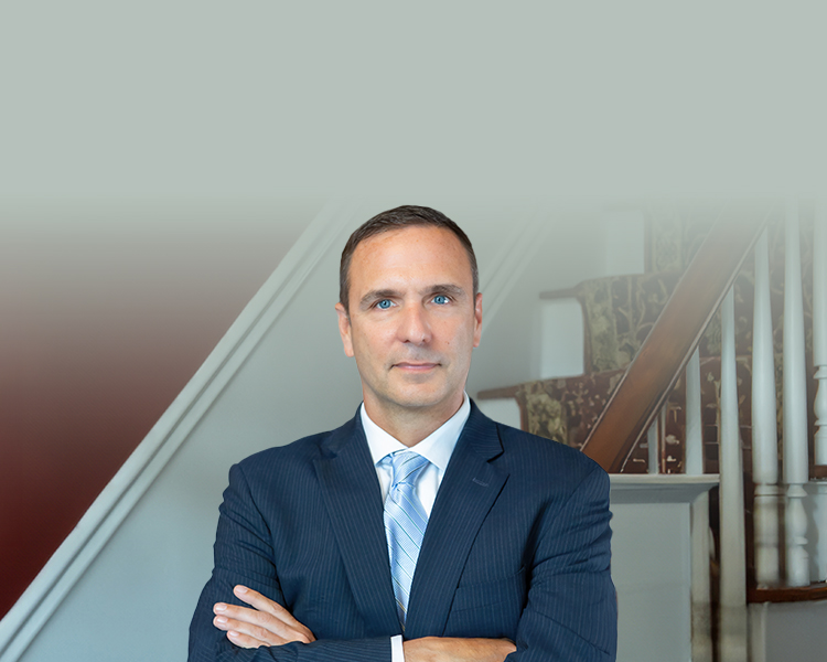 Photograph of Douglas G. Bellon with white stairs in the background.
